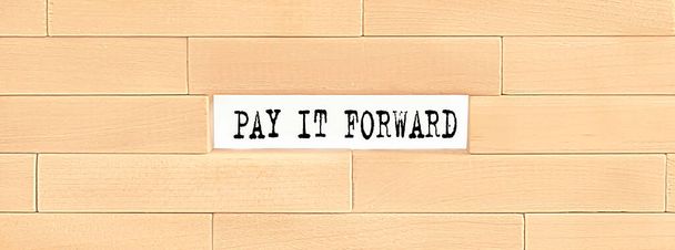 Pay It Forward alphabet letter on wooden background - Photo, Image