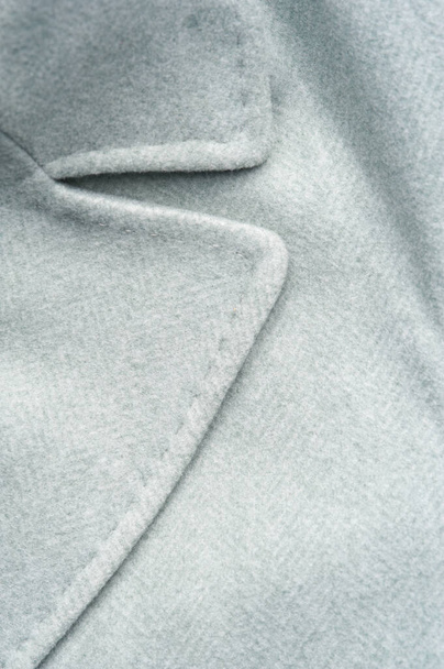 Detail of light blue female coat. Concept of warm everyday things. - Φωτογραφία, εικόνα