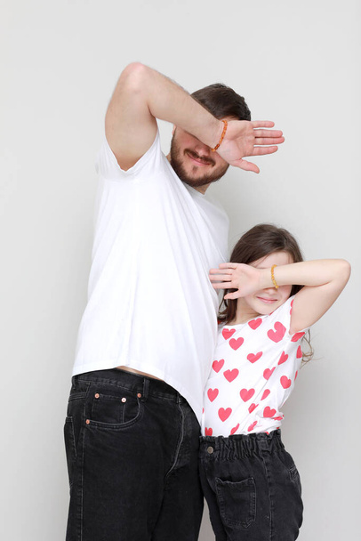 father's day. side view affectionate little child daughter having fun with smiling bearded father. Happy small kid girl enjoying sweet moment with dad on white background trustful relations - 写真・画像