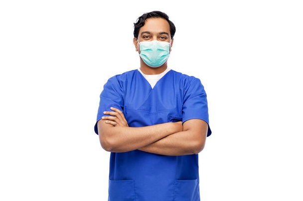 indian male doctor in blue uniform and mask - Фото, зображення