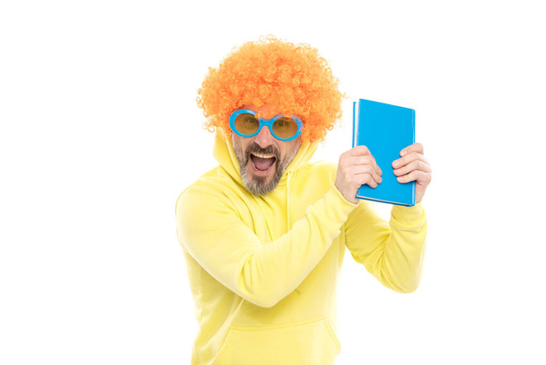 Crazy schoolmaster in orange wig with funky sunglasses shout loud holding library book, school. - 写真・画像
