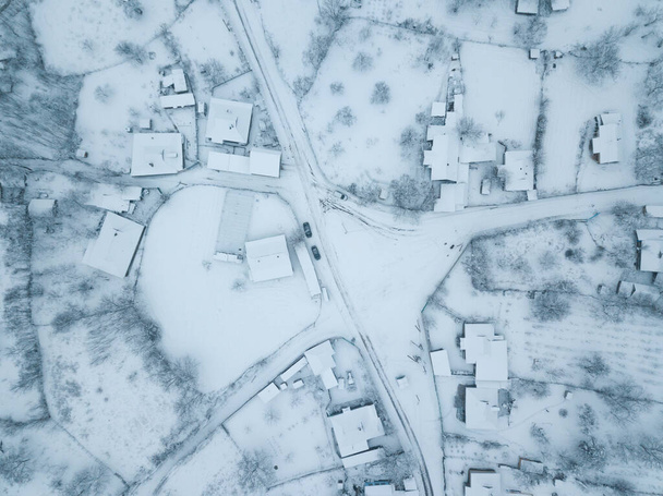 Drone photo of village covered with snow during winter - Photo, Image