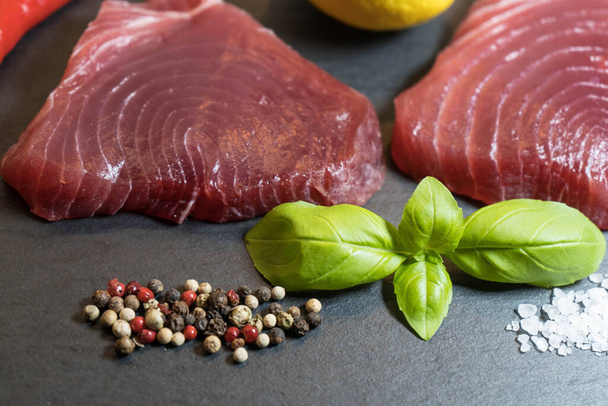 two raw tuna steaks and spices - Φωτογραφία, εικόνα