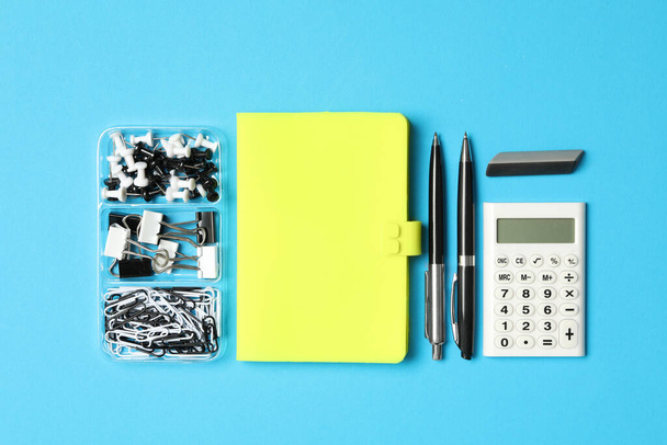 Different stationery on light blue background, flat lay. Back to school - Foto, immagini