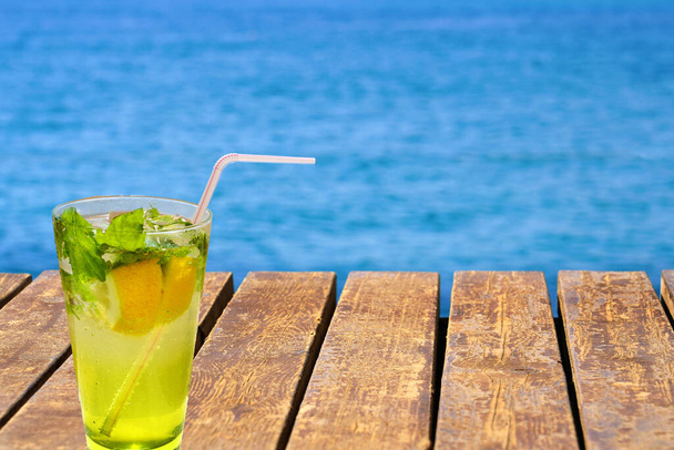                  Cold mojito drink on the wooden beach pier. Summer vacation concept image.               - Fotoğraf, Görsel