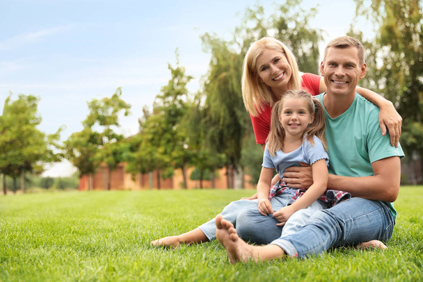 Happy family spending time together in park on sunny summer day - Photo, image