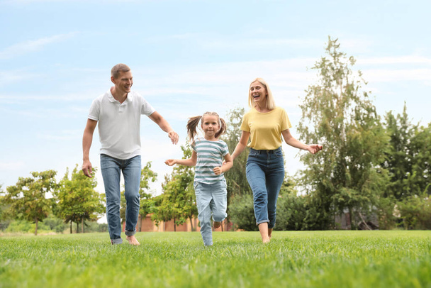 Happy family running in park on summer day - Fotografie, Obrázek