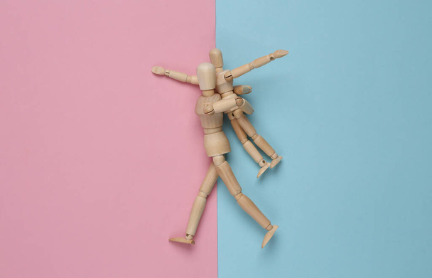 Two puppets impersonating a guardian and a child fooling around against pink blue pastel background. Spending time together. Top view - Photo, Image