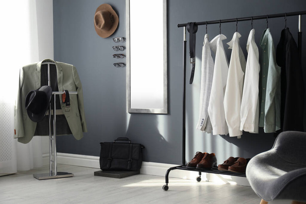 Dressing room interior with clothing rack and mirror - Foto, imagen