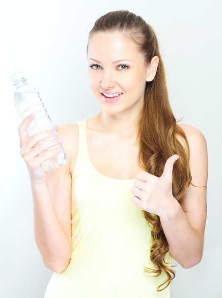 beautiful woman with bottle of water over white - Fotoğraf, Görsel