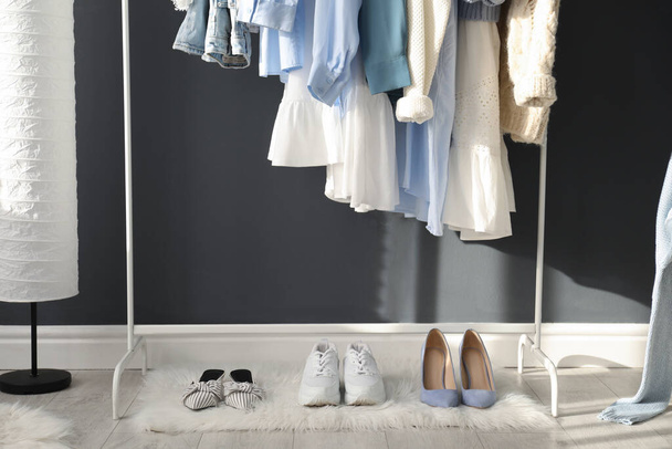 Rack with stylish women's clothes indoors. Interior design - Foto, imagen