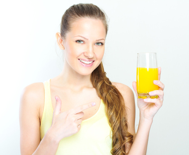 Beautiful happy smiling female with yellow orange juice. - Photo, Image