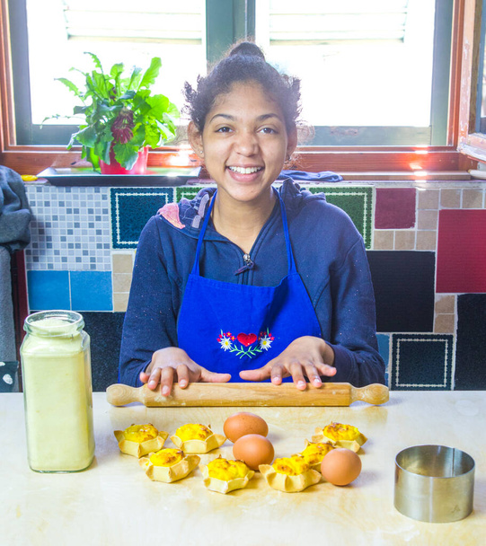 young girl cook cooks delicious pastries made with fresh eggs, ricotta and cream - Photo, image
