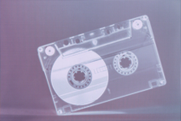 Beautiful Audio cassette tape in neon  light. Minimalism retro style concept. 80s. Background pattern for design. Macro  photography view. Close-up of pixel. - Foto, imagen