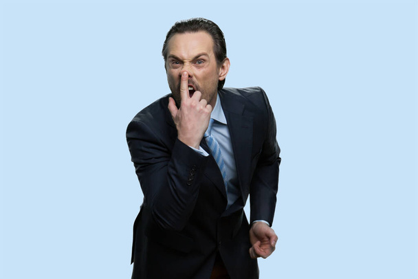 Businessman in suit fooling around touching his nose. - Foto, immagini