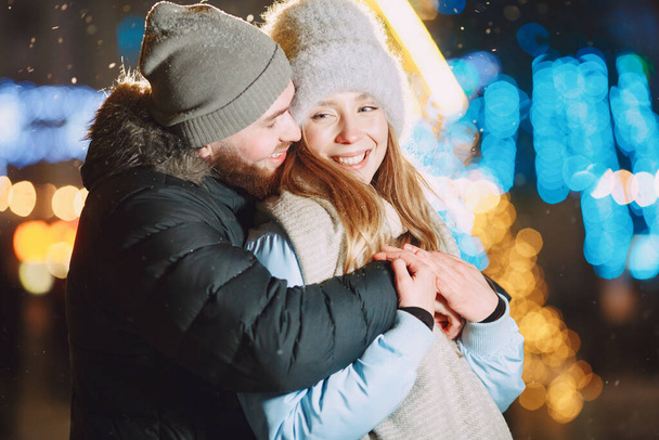 Young couple outdoor in night street at christmas time - Zdjęcie, obraz