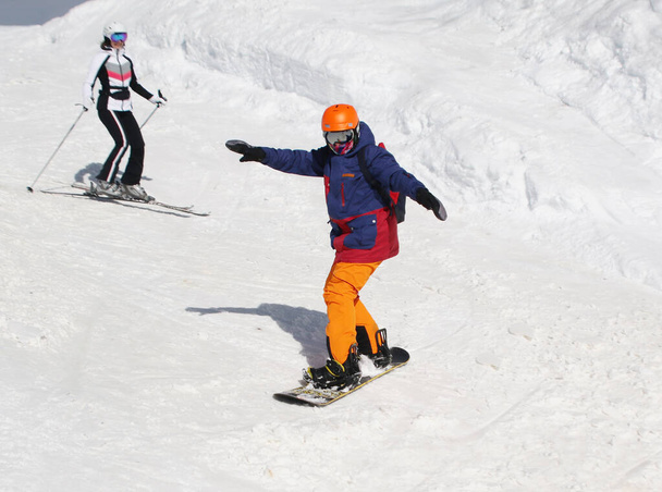 teenager boy   skiing on  snowboard  on slope in ski resort - Foto, Imagen