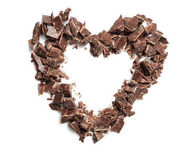 Heart made with dark chocolate crumbles on white background, top view - Foto, immagini