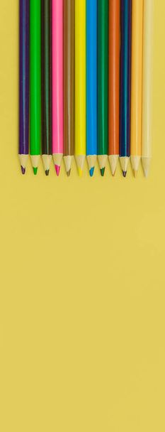 colored pencils on a yellow panorama background - Φωτογραφία, εικόνα