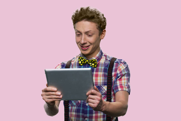 American schoolboy is holding a tablet. - Zdjęcie, obraz