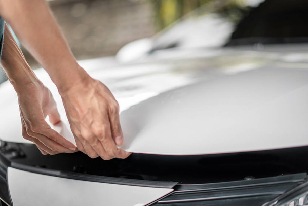Close up of hands being open the car hood or bonnet for maintenance checking engine  before a trip or journey, Car check condition concept. - Foto, Imagem