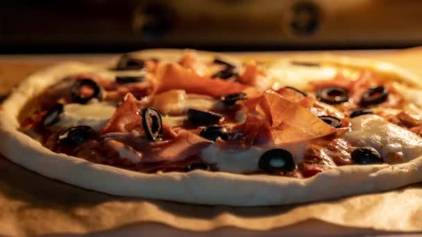 Timelapse of classic Italian pizza with prosciutto baking in an oven.  Trucking camera motion - Footage, Video