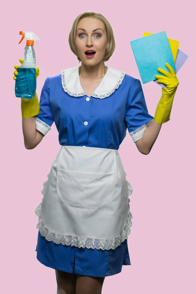 Full-sized portrait of surprised blonde housekeeper. - Zdjęcie, obraz