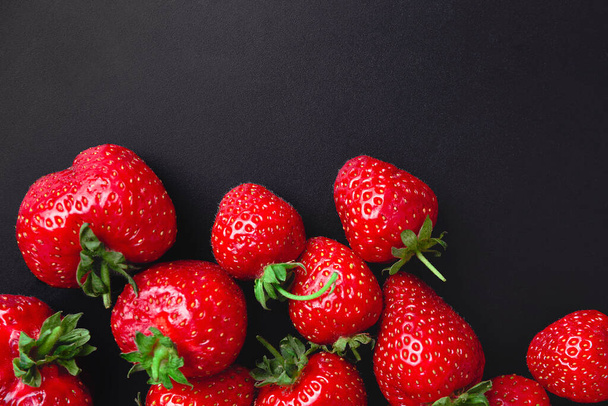 Fond de fraise mûre rouge. Élégant fond sombre avec des baies rouges de fraise sur du béton noir ou de la pierre. Copyspace. gros plan - Photo, image