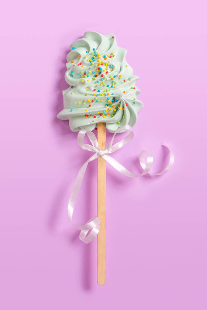 Sweet lollipop on a gentle pastel pink background. - Photo, Image
