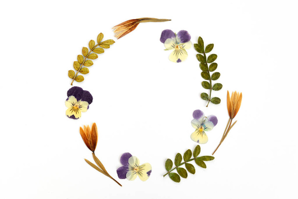 Wreath made from dry leaves and flowes on white background. Dry flowers frame. Flat lay. - Photo, Image