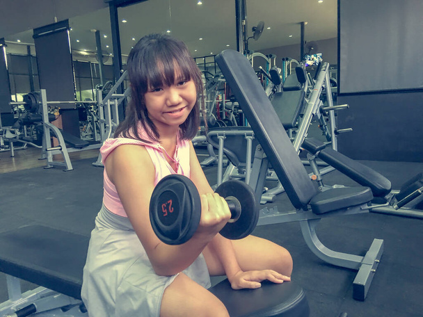 Asie adolescent fille formation haltère dans la salle de gym pour la force. - Photo, image