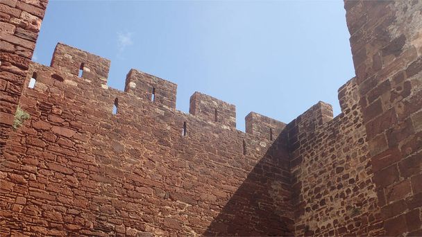 The background of the photo shows of the Portuguese classical castle red brick walls - Photo, Image