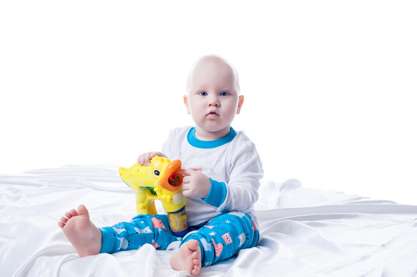 Cute little boy playing with toy in studio - Фото, изображение