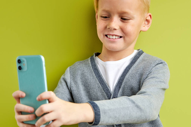 adorable child boy smiling at phones camera - Фото, изображение