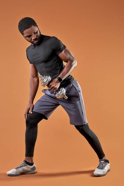 athlete fit young male raising weights, dumbbells - Φωτογραφία, εικόνα
