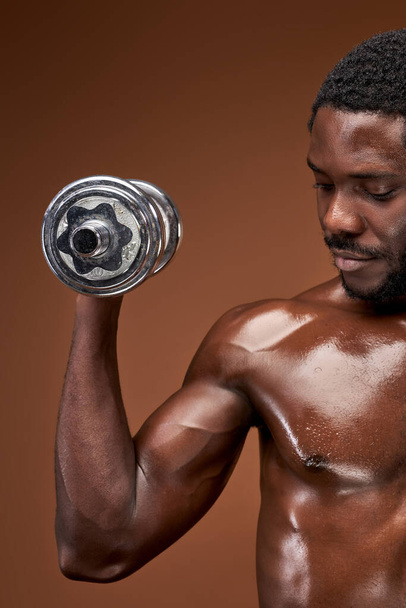 close-up photo of muscular male with dumbbell - Foto, Imagem