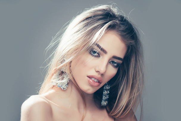 Fashion woman, portrait closeup. Jewelry shop and accessory. Earrings on sexy blonde woman, copy space. - 写真・画像