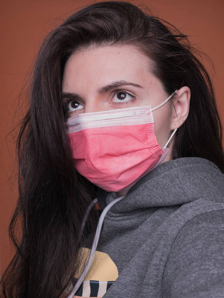 woman with mask on yellow background. covid 19 - Photo, Image