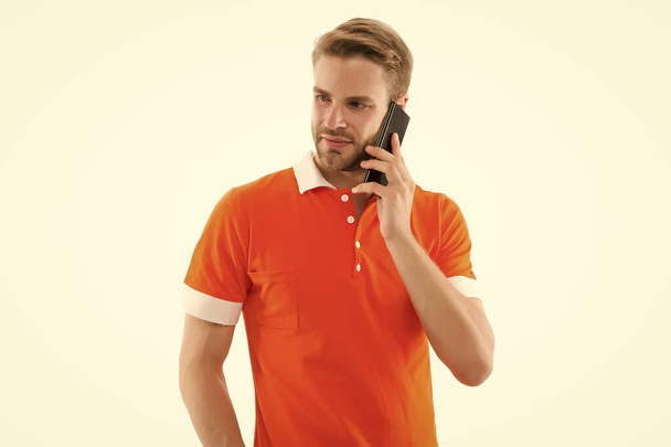 Call friend. Call center. How can I help you. Man casual style phone conversation white background. Man use mobile phone. Modern technology. Listening with attention. Confident guy speak phone - 写真・画像