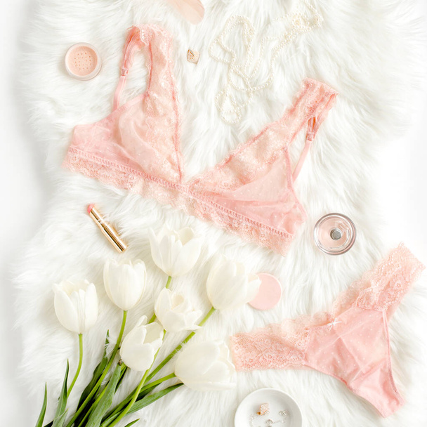 Flat lay set of sexy, lacy, pink lingerie, accessories on white background. Top view. - Фото, изображение