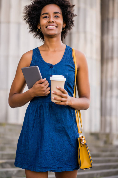 Business woman holding digital tablet and coffee outdoors. - Photo, image