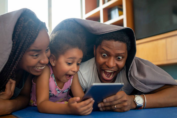 Family using digital tablet at home. - Fotó, kép