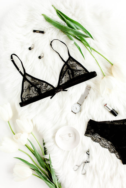 Flat lay stylish, sexy, black lingerie, accessories on a white background. Top view.  - Фото, изображение