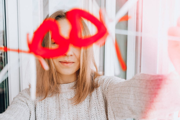 Portrait of beautiful blonde happy woman holding symbol heart. Two red hearts. Girl taking selfie. Alone on Valentines day. Love. Romantic. - Foto, Imagem