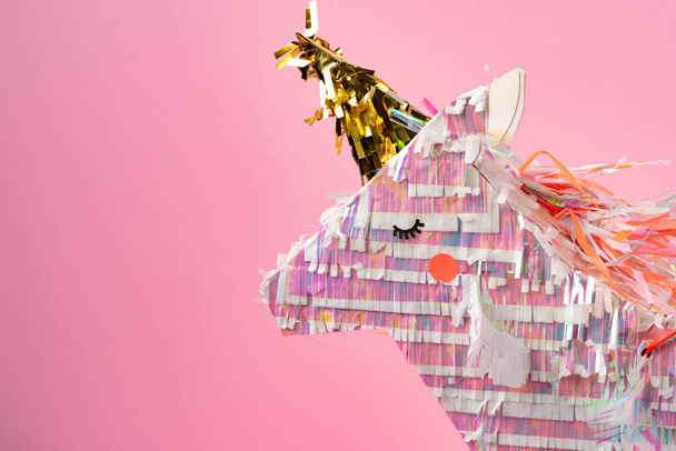 Unicorn pinata for kids party on pink background - Photo, Image