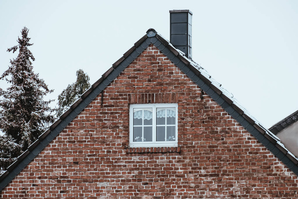The dormer on the roof of a house with a chimney in winter - Photo, image