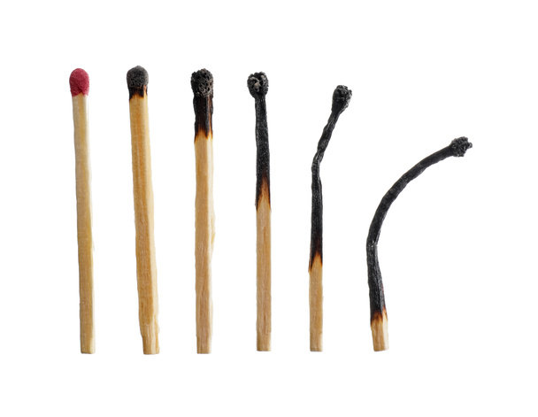One whole match among burnt out ones on white background. Concept of life stages - Photo, Image