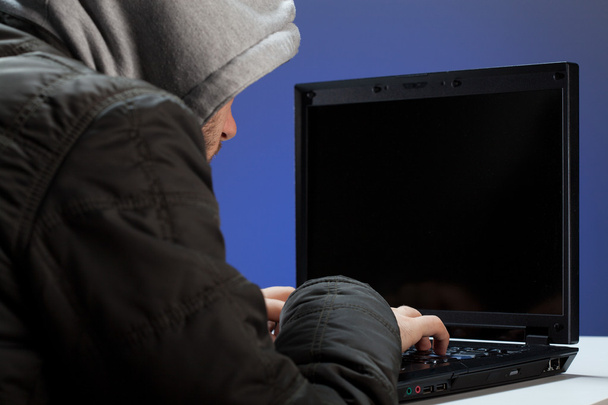 Hacker writing on laptop - Foto, imagen