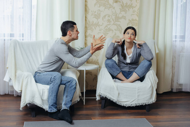 Husband yells at wife, woman doesn't want to listen to him - Photo, image