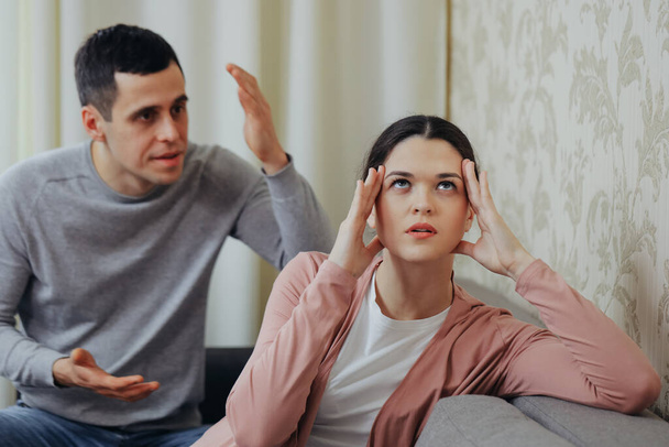 Husband yells at wife, woman is sad - Фото, изображение